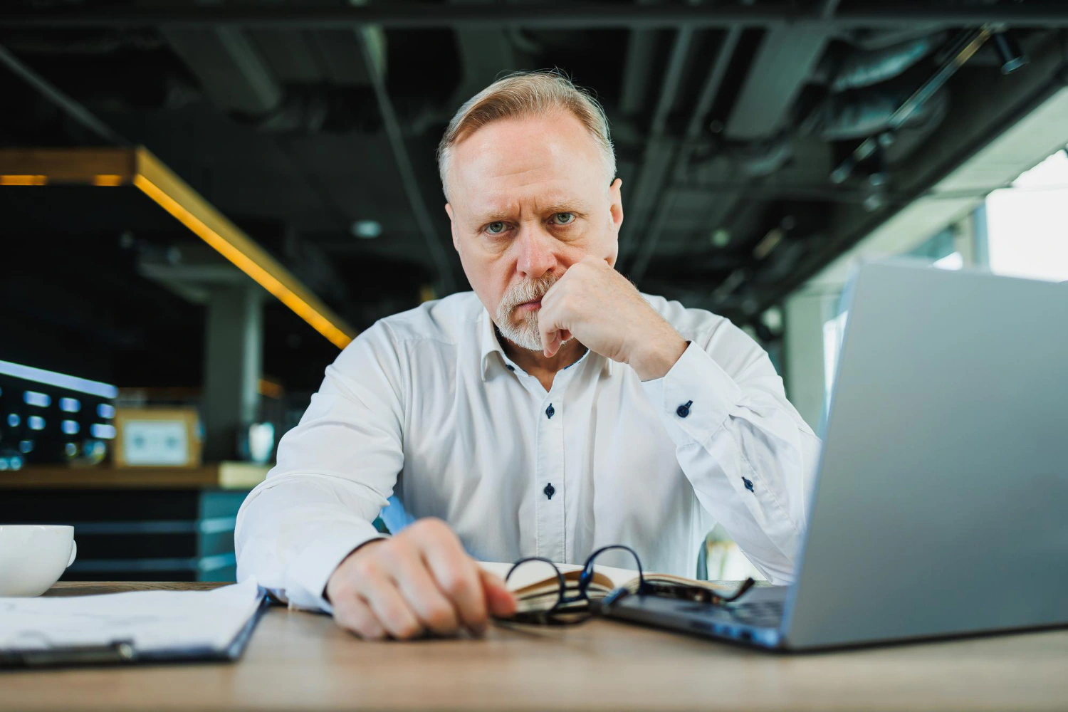 Handwerker sitzt ratlos vor seinem Laptop und schaut auf eine Webseiten-Statistik ohne Anfragen.